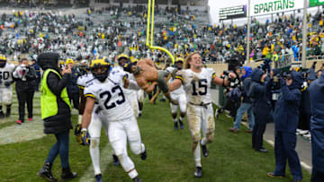 EAST LANSING, MI - OCTOBER 20: Michigan Wolverines linebacker Chase Winovich (15) and safety Tyree Kinnel (23) race around the field with the Paul Bunyan trophy following a Big Ten Conference college football game between Michigan State and Michigan on October 20, 2018, at Spartan Stadium in East Lansing, MI. (Photo by Adam Ruff/Icon Sportswire via Getty Images)