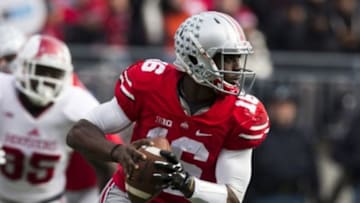 Nov 22, 2014; Columbus, OH, USA; Ohio State Buckeyes quarterback J.T. Barrett (16) looks downfield for an open receiver against the Indiana Hoosiers at Ohio Stadium. Ohio State won the game 42-27. Mandatory Credit: Greg Bartram-USA TODAY Sports