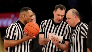 NEW YORK, NEW YORK - MARCH 15: Referees Mike Stephens,Brian O'Connell and Jeff Anderson try and determine fouls and ejections after members of the Seton Hall Pirates and the Marquette Golden Eagles got into an altercation during the semifinal round of the Big East Tournament at Madison Square Garden on March 15, 2019 in New York City. (Photo by Elsa/Getty Images)