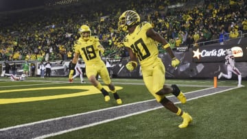 Sep 18, 2021; Athens, Georgia, USA; Oregon Ducks wide receiver Dont'e Thornton (10) celebrates with tight end Terrance Ferguson (19) after scoring a touchdown during the second half against the Stony Brook Seawolves at Sanford Stadium. Mandatory Credit: Joshua L. Jones/Athens Banner-Herald via USA TODAY NETWORK