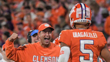 Clemson head coach Dabo Swinney congratulates quarterback D.J. Uiagalelei (5) scoring a nine-yard touchdown against NC State, during the fourth quarter at Memorial Stadium in Clemson, South Carolina Saturday, October 1, 2022.Ncaa Football Clemson Football Vs Nc State Wolfpack