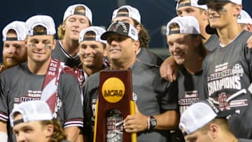 Jun 30, 2021; Omaha, Nebraska, USA; Mississippi St. Bulldogs head coach Chris Lemonis raises the national championship trophy with his team after the win against the Vanderbilt Commodores at TD Ameritrade Park. Mandatory Credit: Steven Branscombe-USA TODAY Sports