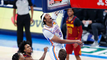 Apr 8, 2021; Oklahoma City, Oklahoma, USA; Oklahoma City Thunder center Moses Brown (9) goes up for a dunk over Cleveland Cavaliers defenders during the second quarter at Chesapeake Energy Arena. Mandatory Credit: Alonzo Adams-USA TODAY Sports