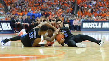 SYRACUSE, NY - FEBRUARY 23: (L-R) Javin DeLaurier #12 of the Duke Blue Devils, Elijah Hughes #33 of the Syracuse Orange and Tre Jones #3 of the Duke Blue Devils battle for the ball during the second half at the Carrier Dome on February 23, 2019 in Syracuse, New York. Duke defeated Syracuse 75-65. (Photo by Rich Barnes/Getty Images)