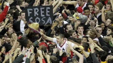 Feb 16, 2013; College Park, MD, USA; Maryland Terrapins fans celebrate with center Alex Len (center) after their 83-81 win over the Duke Blue Devils at the Comcast Center. Mandatory Credit: Mitch Stringer-USA TODAY Sports