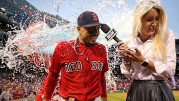 BOSTON, MASSACHUSETTS - SEPTEMBER 29: Mookie Betts #50 of the Boston Red Sox and NESN host Guerin Austin are doused in Gatorade after Betts scored the game winning run to defeat Baltimore Orioles 5-4 at Fenway Park on September 29, 2019 in Boston, Massachusetts. (Photo by Maddie Meyer/Getty Images)