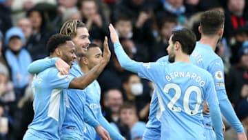 Manchester City's English midfielder Raheem Sterling (L) celebrates with teammates after scoring his team's first goal during the English Premier League football match between Manchester City and Wolverhampton Wanderers at the Etihad Stadium in Manchester, north west England, on December 11, 2021. - RESTRICTED TO EDITORIAL USE. No use with unauthorized audio, video, data, fixture lists, club/league logos or 'live' services. Online in-match use limited to 120 images. An additional 40 images may be used in extra time. No video emulation. Social media in-match use limited to 120 images. An additional 40 images may be used in extra time. No use in betting publications, games or single club/league/player publications. (Photo by NIGEL RODDIS / AFP) / RESTRICTED TO EDITORIAL USE. No use with unauthorized audio, video, data, fixture lists, club/league logos or 'live' services. Online in-match use limited to 120 images. An additional 40 images may be used in extra time. No video emulation. Social media in-match use limited to 120 images. An additional 40 images may be used in extra time. No use in betting publications, games or single club/league/player publications. / RESTRICTED TO EDITORIAL USE. No use with unauthorized audio, video, data, fixture lists, club/league logos or 'live' services. Online in-match use limited to 120 images. An additional 40 images may be used in extra time. No video emulation. Social media in-match use limited to 120 images. An additional 40 images may be used in extra time. No use in betting publications, games or single club/league/player publications. (Photo by NIGEL RODDIS/AFP via Getty Images)