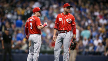 MILWAUKEE, WI - SEPTEMBER 19: Scooter Gennett #3 and Joey Votto #19 of the Cincinnati Reds meet in the sixth inning against the Milwaukee Brewers at Miller Park on September 19, 2018 in Milwaukee, Wisconsin. (Photo by Dylan Buell/Getty Images)