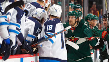 ST. PAUL, MN - NOVEMBER 23: Marcus Foligno #17 of the Minnesota Wild goes into the Winnipeg Jets bench to defend his teammate Nick Seeler #36 of the Minnesota Wild who was pushed in there by Adam Lowry #17 of the Winnipeg Jets during a game at Xcel Energy Center on November 23, 2018 in St. Paul, Minnesota. The Wild defeated the Jets 4-2.(Photo by Bruce Kluckhohn/NHLI via Getty Images)