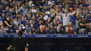 TORONTO, ON - SEPTEMBER 21: A fan reacts towards home plate umpire Ben May