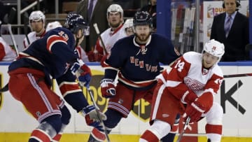 Apr 9, 2016; New York, NY, USA; Detroit Red Wings center Gustav Nyquist (14) passes the puck in front of New York Rangers defenseman Kevin Klein (8) and right wing Kevin Hayes (13) during the first period at Madison Square Garden. Mandatory Credit: Adam Hunger-USA TODAY Sports