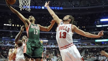 Apr 4, 2014; Chicago, IL, USA; Chicago Bulls center Joakim Noah (13) defends Milwaukee Bucks guard Ramon Sessions (13) during the first half at the United Center. Mandatory Credit: David Banks-USA TODAY Sports