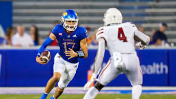 Sep 3, 2021; Lawrence, Kansas, USA; Kansas Jayhawks quarterback Jason Bean (17) runs the ball against South Dakota Coyotes defensive back Elijah Reed (4) during the first half at David Booth Kansas Memorial Stadium. Mandatory Credit: Jay Biggerstaff-USA TODAY Sports