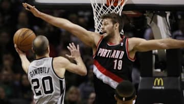 Jan 17, 2014; San Antonio, TX, USA; San Antonio Spurs guard Manu Ginobili (20) drives to the basket as Portland Trail Blazers center Joel Freeland (19) defends during the first half at AT&T Center. Mandatory Credit: Soobum Im-USA TODAY Sports