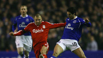 LIVERPOOL, UNITED KINGDOM - FEBRUARY 04: Andrea Dossena of Liverpool is tackled by Mikel Arteta of Everton during the FA Cup fourth round replay match sponsored by e.on between Everton and Liverpool at Goodison Park on February 4, 2009 in Everton, England. (Photo by Alex Livesey/Getty Images)