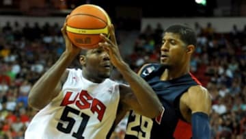 Aug 1, 2014; Las Vegas, NV, USA; USA Team White forward Paul Milsap (51) drives the ball against the defense of USA Team Blue guard Paul George (29) during the USA Basketball Showcase at Thomas & Mack Center. Mandatory Credit: Stephen R. Sylvanie-USA TODAY Sports