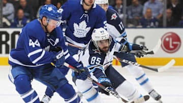 Mathieu Perreault #85 of the Winnipeg Jets battles against Morgan Rielly #44 of the Toronto Maple Leafs during an NHL game at Scotiabank Arena. (Photo by Claus Andersen/Getty Images)