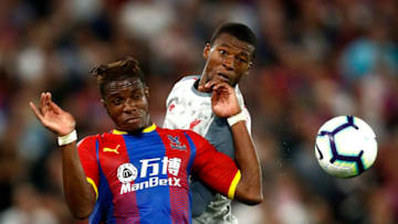 LONDON, ENGLAND - AUGUST 20: Wilfried Zaha of Crystal Palace and Georginio Wijnaldum of Liverpool battle for the header during the Premier League match between Crystal Palace and Liverpool FC at Selhurst Park on August 20, 2018 in London, United Kingdom. (Photo by Julian Finney/Getty Images)