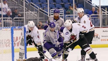 ORLANDO, FL - FEBRUARY 12: Eric Faille #27 of Orlando Solar Bears is stopped by Matt Ginn #90 of teh Atlanta Gladiators (ECHL affiliate of the Boston Bruins) on February 12, 2016 in Orlando, Florida. (Photo by Bruce Bennett/Getty Images)