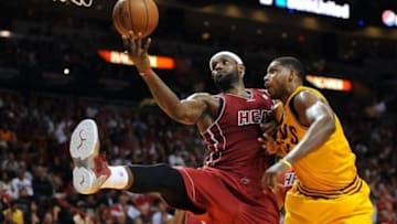 Dec 14, 2013; Miami, FL, USA; Miami Heat small forward LeBron James (6) gains control of a loose ball as Cleveland Cavaliers power forward Tristan Thompson (13) defends during the first half at American Airlines Arena. Mandatory Credit: Steve Mitchell-USA TODAY Sports