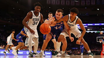 NEW YORK, NEW YORK - NOVEMBER 09: Mitch Lightfoot #44 of the Kansas Jayhawks and Max Christie #5 of the Michigan State Spartans pursue the loose ball during the State Farm Champions Classic at Madison Square Garden on November 09, 2021 in New York City. (Photo by Mike Stobe/Getty Images)