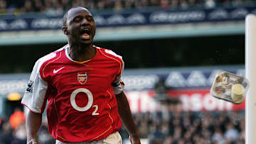 LONDON - NOVEMBER 13: A Spurs fan throws a carton of drinks at Patrick Vieira of Arsenal as he celebrates his goal during the Barclays Premiership match between Tottenham Hotspur and Arsenal at White Hart Lane on November 13, 2004 in London, England. (Photo by Ian Walton/Getty Images)