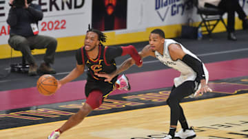CLEVELAND, OHIO - MARCH 19: Darius Garland #10 of the Cleveland Cavaliers brings the ball up court around Dejounte Murray #5 of the San Antonio Spurs during the second quarter at Rocket Mortgage Fieldhouse on March 19, 2021 in Cleveland, Ohio. NOTE TO USER: User expressly acknowledges and agrees that, by downloading and/or using this photograph, user is consenting to the terms and conditions of the Getty Images License Agreement. (Photo by Jason Miller/Getty Images)