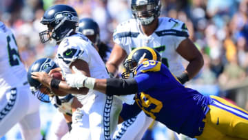 LOS ANGELES, CA - OCTOBER 08: Aaron Donald #99 of the Los Angeles Rams dives to get to Russell Wilson #3 of the Seattle Seahawks during the game at Los Angeles Memorial Coliseum on October 8, 2017 in Los Angeles, California. (Photo by Harry How/Getty Images)