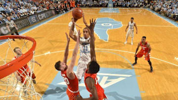 Feb 29, 2016; Chapel Hill, NC, USA; North Carolina Tar Heels forward Brice Johnson (11) shoots as Syracuse Orange forwards Tyler Lydon (20) and Tyler Roberson (21) defend in the second half. The Tar Heels defeated Syracuse Orange 75-70 at Dean E Smith Center. Mandatory Credit: Bob Donnan-USA TODAY Sports