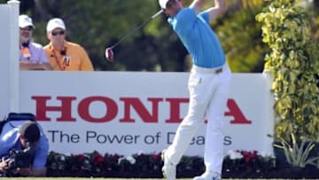 Mar 2, 2014; Palm Beach Gardens, FL, USA; Rory MCIlroy tees off on the eighth hole during the final round of The Honda Classic golf tournament at PGA National GC Champion Course. Mandatory Credit: Brad Barr-USA TODAY Sports