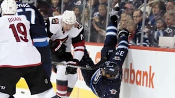 Nov 21, 2015; Winnipeg, Manitoba, CAN; Winnipeg Jets defenceman Dustin Byfuglien (33) is hit by Arizona Coyotes center Martin Hanzal (11) during the third period at MTS Centre. Winnipeg wins 3-2. Mandatory Credit: Bruce Fedyck-USA TODAY Sports