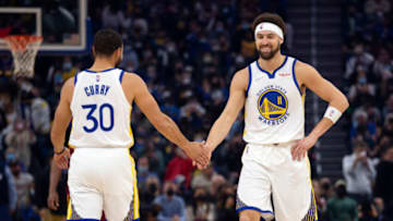 Jan 9, 2022; San Francisco, California, USA; Golden State Warriors guard Klay Thompson (11) gets a congratulatory handshake from teammate Stephen Curry (30) after making a basket against the Cleveland Cavaliers during the first quarter at Chase Center. Mandatory Credit: D. Ross Cameron-USA TODAY Sports