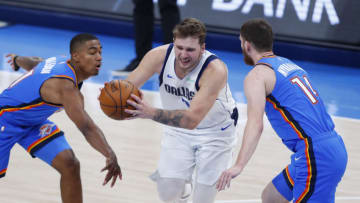 Mar 29, 2021; Oklahoma City, Oklahoma, USA; Dallas Mavericks guard Luka Doncic (middle) drives to the basket between Oklahoma City Thunder guard Theo Maledon (left) and guard Svi Mykhailiuk (14) during the second half at Chesapeake Energy Arena. Mandatory Credit: Alonzo Adams-USA TODAY Sports