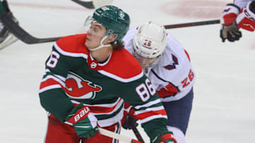 Washington Capitals center Nic Dowd (26) hits New Jersey Devils center Jack Hughes (86) during the third period at Prudential Center. Mandatory Credit: Ed Mulholland-USA TODAY Sports