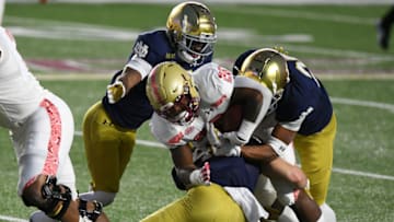 Nov 14, 2020; Chestnut Hill, Massachusetts, USA; Boston College Eagles running back David Bailey (26) is tackled by Notre Dame Fighting Irish linebacker Drew White (40), safety Shaun Crawford (20), and cornerback Clarence Lewis (26) during the first half at Alumni Stadium. Mandatory Credit: Brian Fluharty-USA TODAY Sports