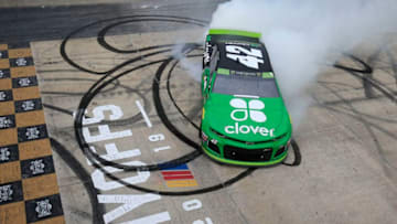 DOVER, DELAWARE - OCTOBER 06: Kyle Larson, driver of the #42 Clover Chevrolet, celebrates with a burnout after winning the Monster Energy NASCAR Cup Series Drydene 400 at Dover International Speedway on October 06, 2019 in Dover, Delaware. (Photo by Chris Trotman/Getty Images)