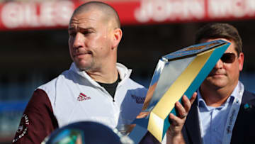 Jan 2, 2023; Tampa, FL, USA; Mississippi State Bulldogs head coach Zach Arnett is presented the trophy after beating the Illinois Fighting Illini in the 2023 ReliaQuest Bowl at Raymond James Stadium. Mandatory Credit: Nathan Ray Seebeck-USA TODAY Sports