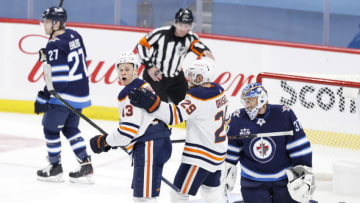 Apr 17, 2021; Winnipeg, Manitoba, CAN; Edmonton Oilers right wing Jesse Puljujarvi (13) celebrates his goal against the Winnipeg Jets with Edmonton Oilers center Leon Draisaitl (29) during the third period at Bell MTS Place. Mandatory Credit: James Carey Lauder-USA TODAY Sports
