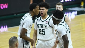 Mar 7, 2021; East Lansing, Michigan, USA; Michigan State Spartans forward Malik Hall (25) celebrates with forward Marcus Bingham Jr. (30) and forward Gabe Brown (44) during the second half against the Michigan Wolverines at Jack Breslin Student Events Center. Mandatory Credit: Tim Fuller-USA TODAY Sports
