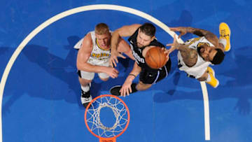 ORLANDO, FL - DECEMBER 8: Nikola Vucevic #9 of the Orlando Magic drives to the basket against the Denver Nuggets on December 8, 2017 at the Amway Center in Orlando, Florida. NOTE TO USER: User expressly acknowledges and agrees that, by downloading and or using this Photograph, user is consenting to the terms and conditions of the Getty Images License Agreement. Mandatory Copyright Notice: Copyright 2017 NBAE (Photo by Fernando Medina/NBAE via Getty Images)