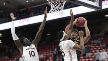 Jan 26, 2021; Auburn, Alabama, USA; Missouri Tigers guard Mark Smith (right) shoots against Auburn basketball guard Devan Cambridge (35) and forward JT Thor (10) during the second half at Auburn Arena. Mandatory Credit: John Reed-USA TODAY Sports