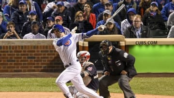 Oct 30, 2016; Chicago, IL, USA; Chicago Cubs third baseman Kris Bryant (left) hits a solo home run against Cleveland Indians catcher Roberto Perez (center) during the fourth inning in game five of the 2016 World Series at Wrigley Field. Mandatory Credit: Tommy Gilligan-USA TODAY Sports