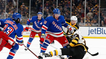 BOSTON, MA - MARCH 27: New York Rangers left wing Brendan Lemieux (48) spills Boston Bruins center Patrice Bergeron (37) during a game between the Boston Bruins and the New York Rangers on March 27, 2019, at TD Garden in Boston, Massachusetts. (Photo by Fred Kfoury III/Icon Sportswire via Getty Images)