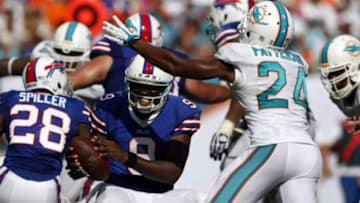 Oct 20, 2013; Miami Gardens, FL, USA; Miami Dolphins cornerback Dimitri Patterson (24) sacks Buffalo Bills quarterback Thad Lewis (9) in the second half at Sun Life Stadium. Mandatory Credit: Robert Mayer-USA TODAY Sports