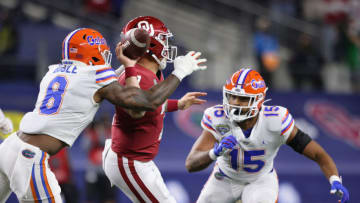 ARLINGTON, TEXAS - DECEMBER 30: Linebacker Khris Bogle #8 of the Florida Gators forces a fumble on quarterback Spencer Rattler #7 of the Oklahoma Sooners during the first quarter at AT&T Stadium on December 30, 2020 in Arlington, Texas. (Photo by Ronald Martinez/Getty Images)