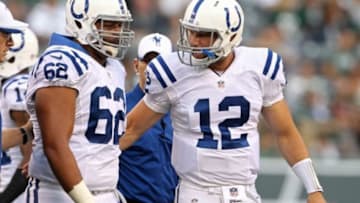 Aug 7, 2014; East Rutherford, NJ, USA; Indianapolis Colts center Khaled Holmes (62) walks off the field talking with quarterback Andrew Luck (12) against the New York Jets during the first quarter at MetLife Stadium. Mandatory Credit: Adam Hunger-USA TODAY Sports