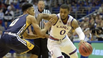 Nov 13, 2015; Lawrence, KS, USA; Kansas Jayhawks guard Frank Mason III (0) dribbles around Northern Colorado Bears guard Jordan Davis (0) in the second half at Allen Fieldhouse. Kansas won the game 109-72. Mandatory Credit: John Rieger-USA TODAY Sports