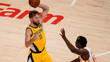 Apr 18, 2021; Atlanta, Georgia, USA; Indiana Pacers forward Domantas Sabonis (11) holds the ball above Atlanta Hawks center Clint Capela (15) during the first quarter at State Farm Arena. Mandatory Credit: Dale Zanine-USA TODAY Sports