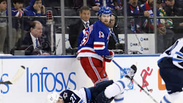 NEW YORK, NEW YORK - FEBRUARY 20: Alexis Lafreniere #13 of the New York Rangers trips up Nikolaj Ehlers #27 of the Winnipeg Jets during the third period at Madison Square Garden on February 20, 2023 in New York City. The Jets defeated the Rangers 4-1. (Photo by Bruce Bennett/Getty Images)