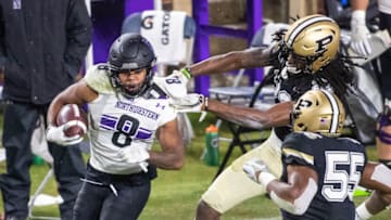 Nov 14, 2020; West Lafayette, Indiana, USA; Northwestern Wildcats wide receiver Kyric McGowan (8) runs the ball while Purdue Boilermakers safety Cory Trice (23) defends in the game at Ross-Ade Stadium. Mandatory Credit: Trevor Ruszkowski-USA TODAY Sports